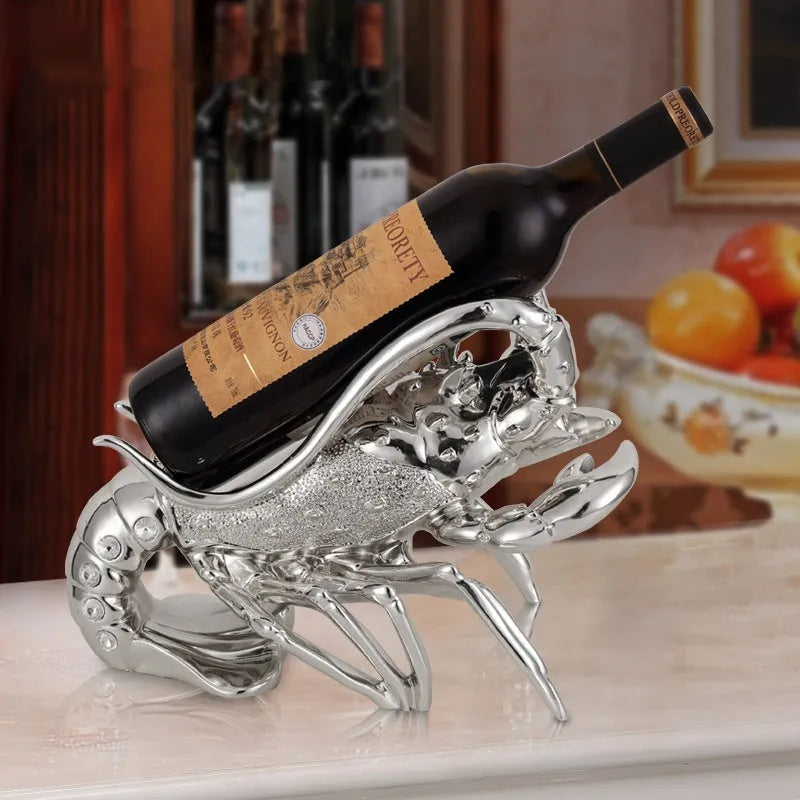 Lobster-shaped wine rack ornament in rose gold or silver metallic finish on tabletop