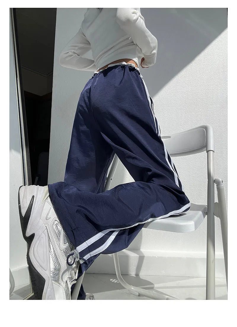 Women's loose straight-leg trousers with contrast ribbon detail in navy blue.