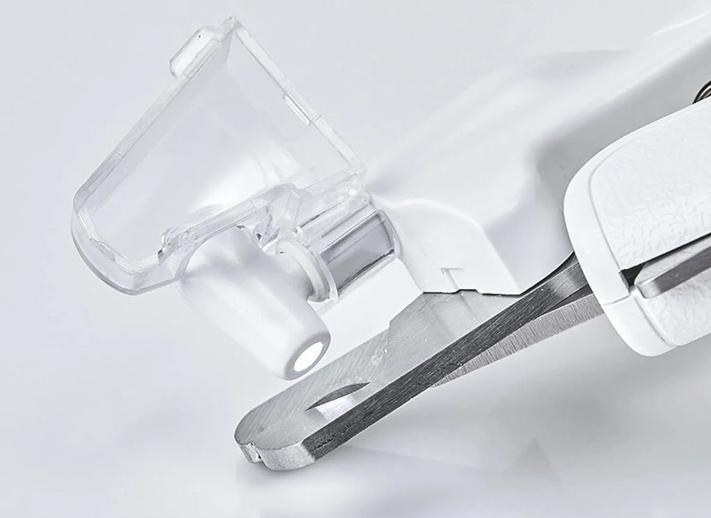 White pet nail clippers with built-in LED light and transparent anti-splash guard.