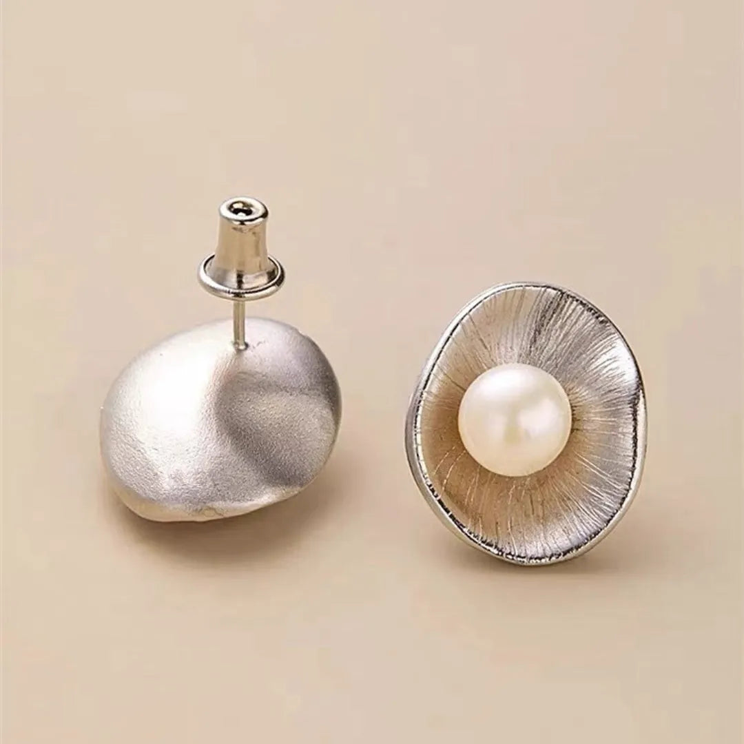 Gold electroplated sterling silver pearl ear studs with geometric design and surgical steel posts