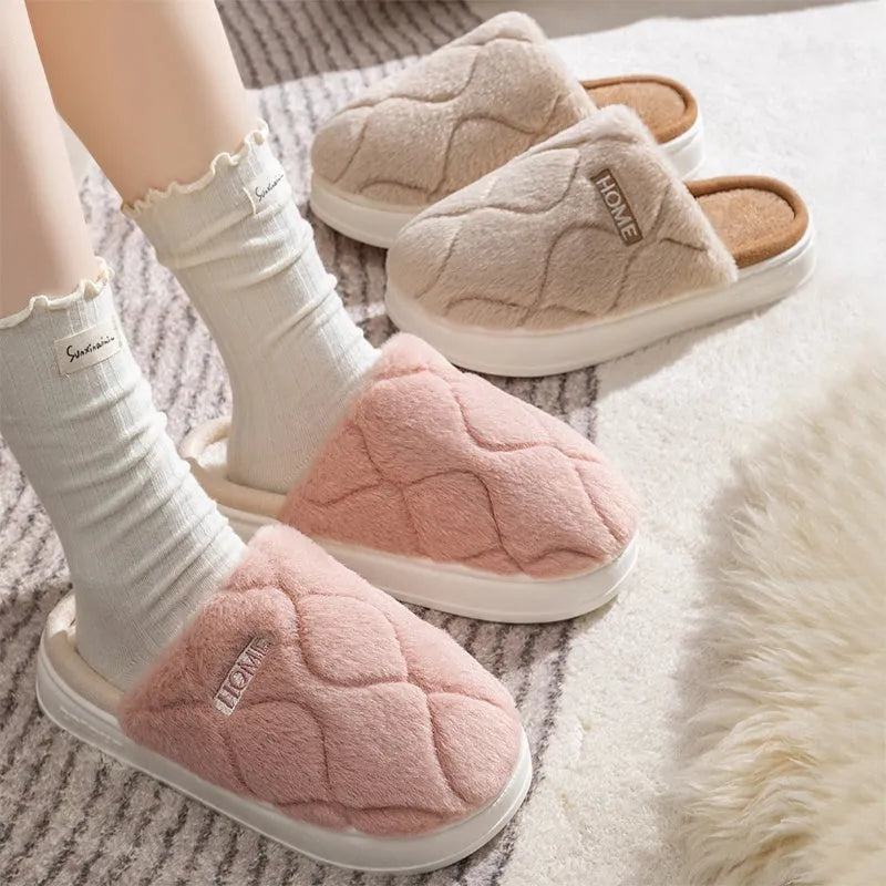 Plush indoor slippers in light gray with car stitching detail on the upper and PVC sole