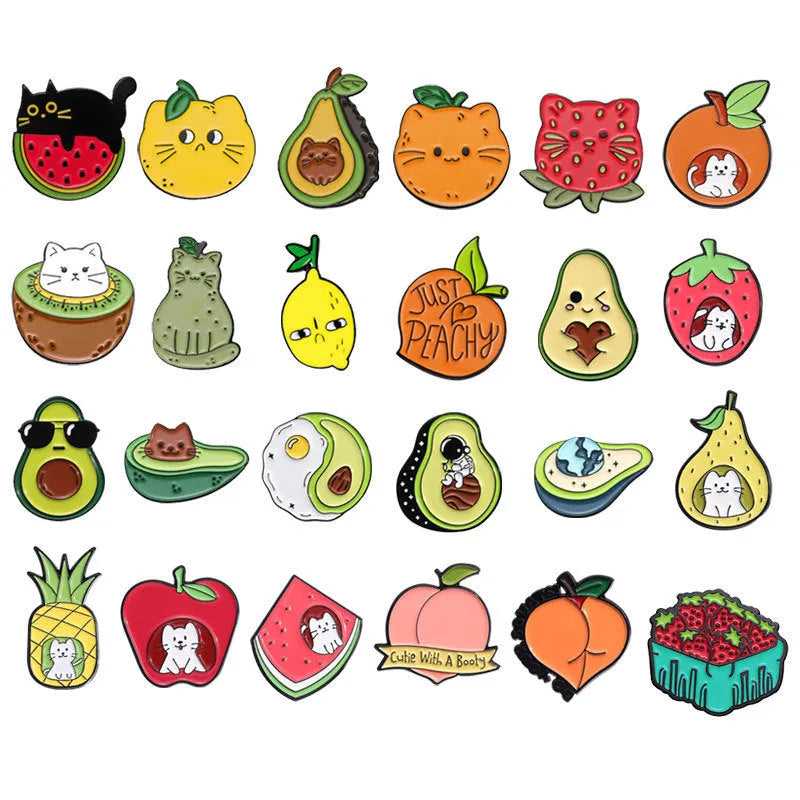 Colourful cartoon fruit design metal letter brooch on a fabric background.