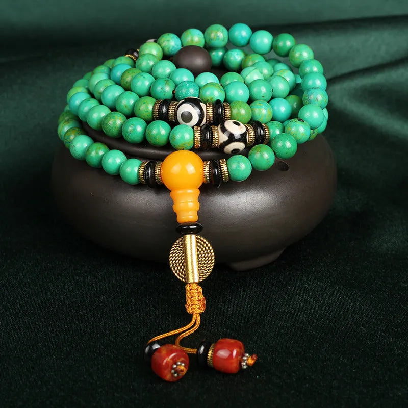 Natural turquoise bracelet with 108 round 8mm beads on a white background