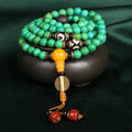 Natural turquoise bracelet with 108 round 8mm beads on a white background