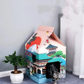 Foldable corrugated paper cat scratching board in Nagoya colour, shown functioning as both a scratching surface and a cat nest.