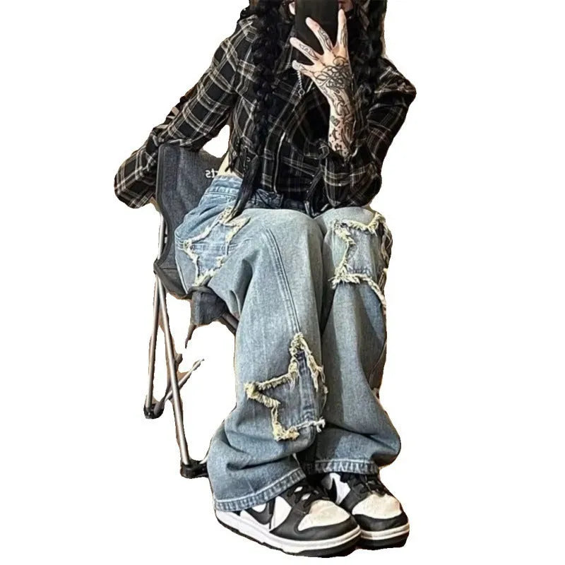 Blue high waist wide-leg denim trousers on a hanger, showing straight leg cut.