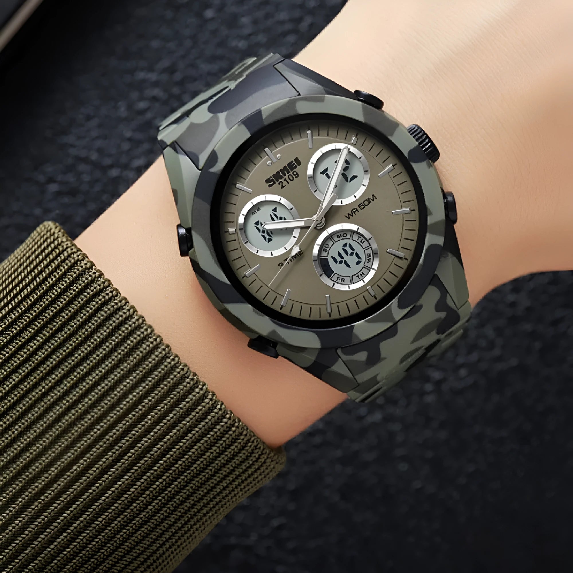 Men's and women's electronic casual watch with a black TPU strap and camouflage-pattern dial on a wrist.