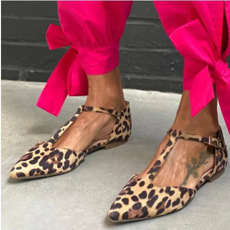 Women's leopard print pointed toe pumps with a low chunky heel and a cross shoulder strap.