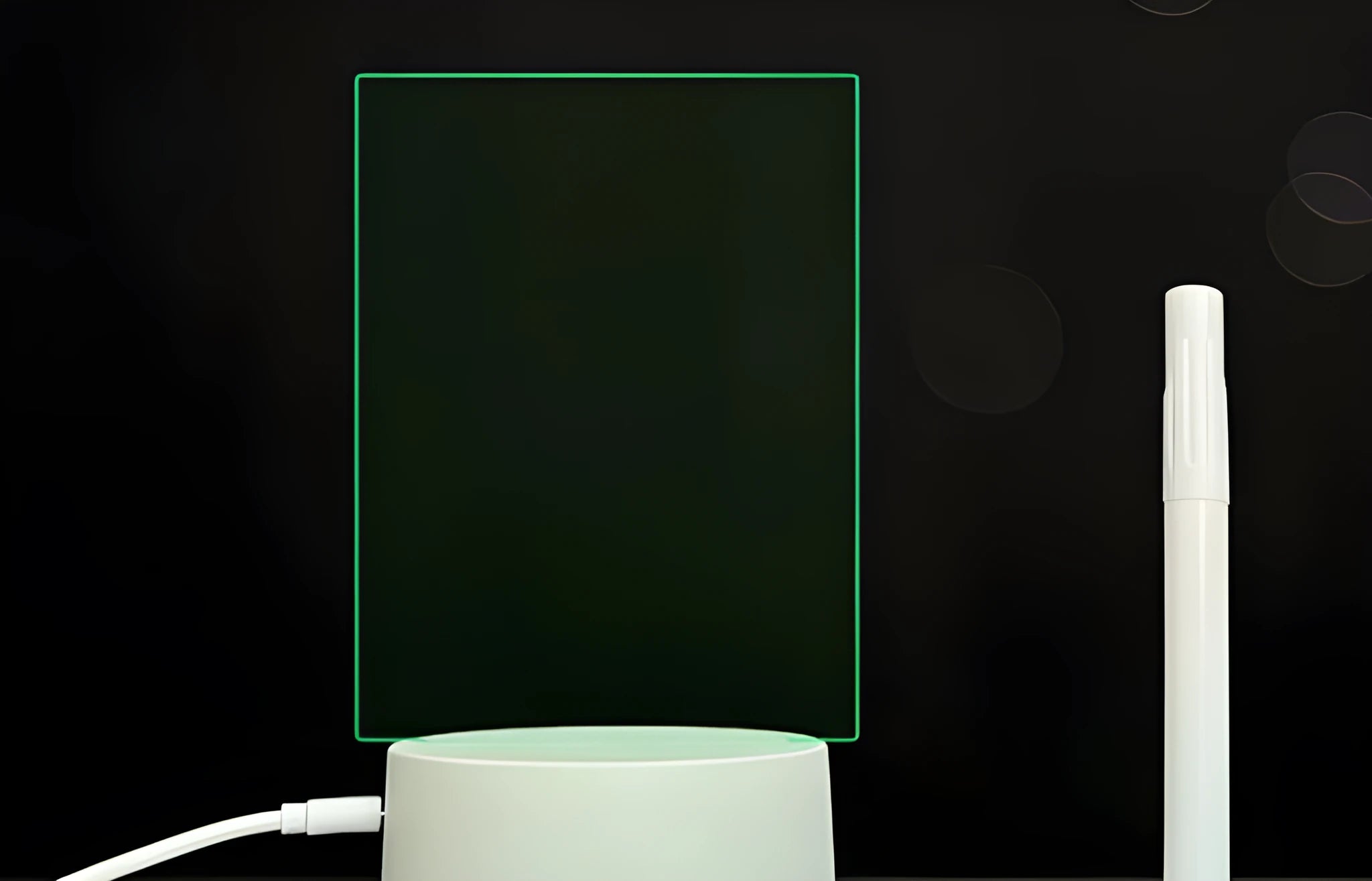 3D acrylic LED message board night light with remote control and marker pen on a desk.