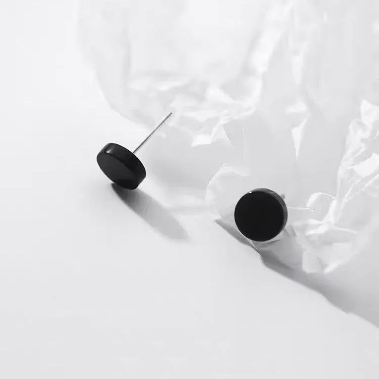 S999 sterling silver flat ear bone studs in round shape, showing silver and black colour options.