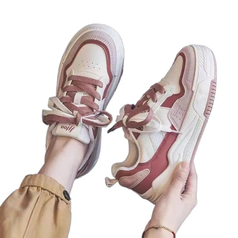 Women's pink low-top sneakers with imitation leather upper and rubber sole for hidden height increase.
