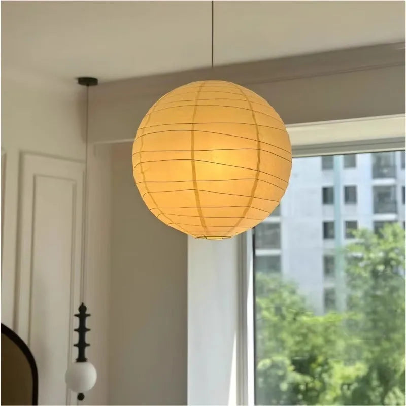 Japanese-style spherical rice paper chandelier pendant light in a living room setting.