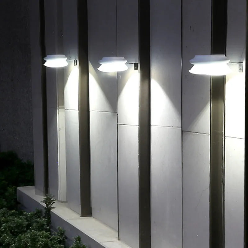 Solar-powered outdoor fence wall lamp with Southeast Asian design in garden setting