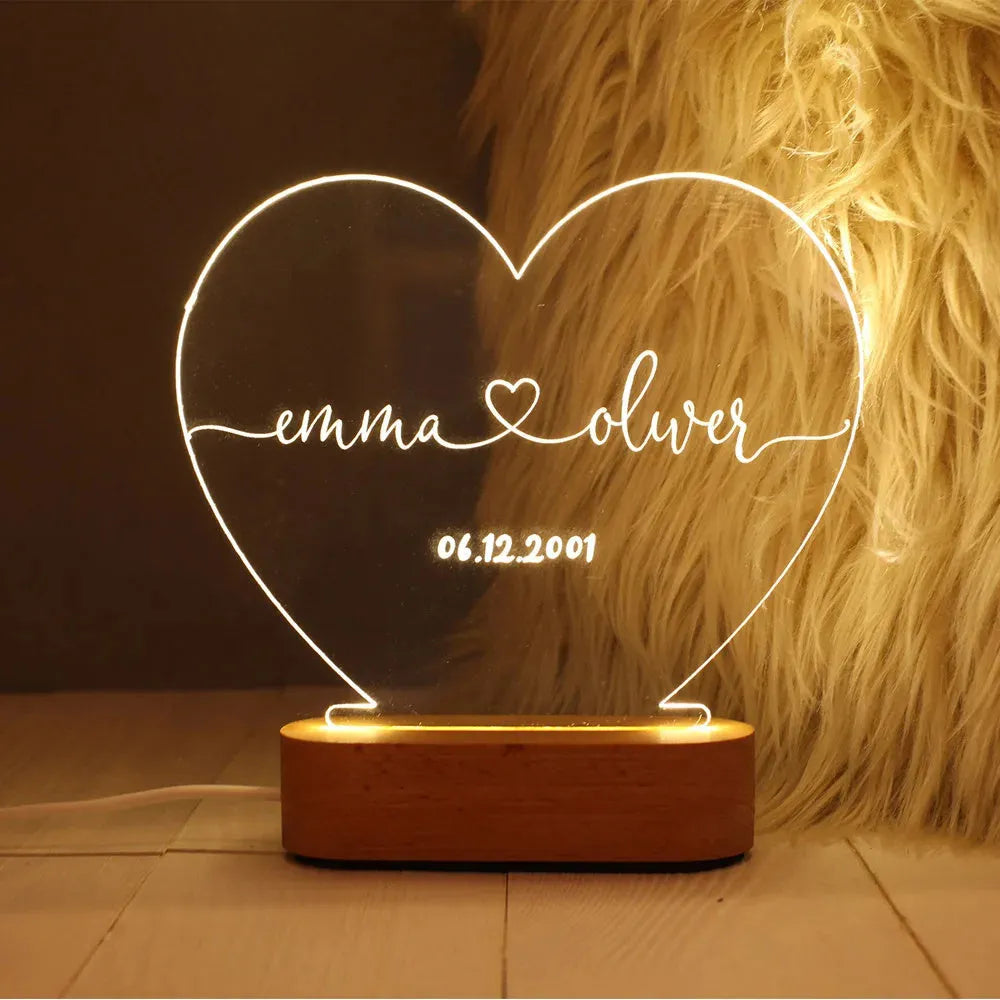 Personalised acrylic LED night light showing custom names and dates with transparent 20x11.5cm design