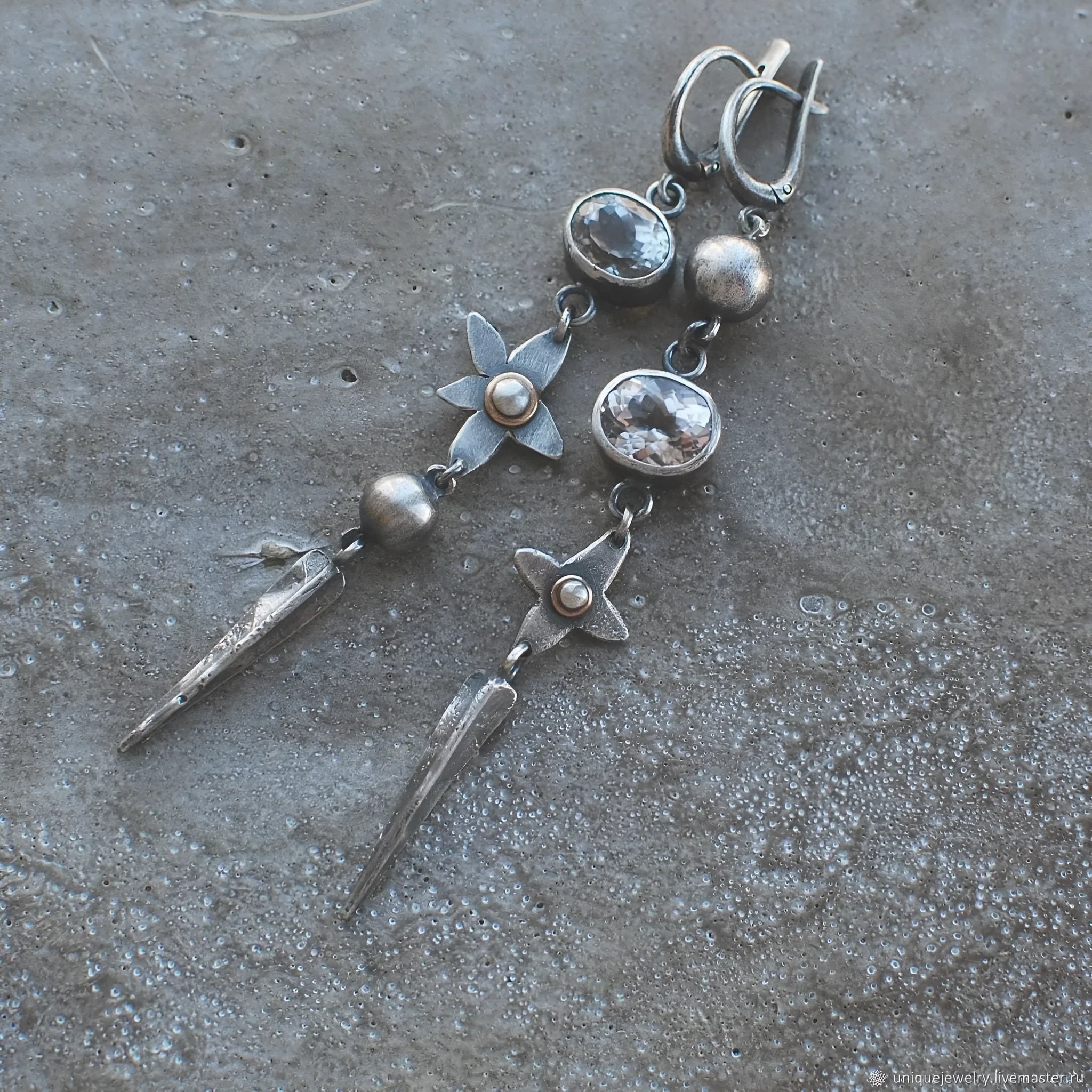 Geometric long pendant earrings with rhinestone drops in antique silver finish.