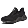 Steel toe cap safety work shoes in black with low-cut design, shown on a work site background.
