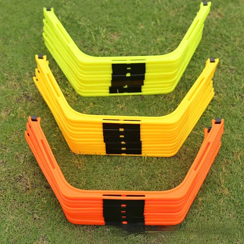 Set of six foldable yellow, green, and orange hexagon agility training rings on grass.