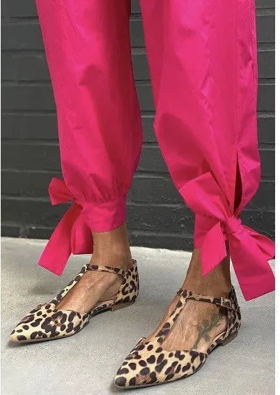 Women's leopard print pointed toe pumps with a low chunky heel and a cross shoulder strap.