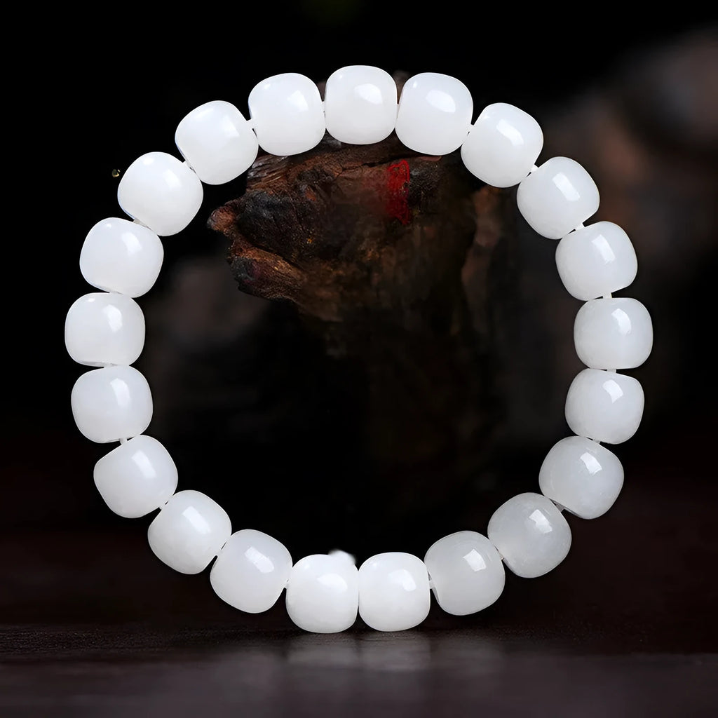 White jade barrel bead bracelet on wrist showing traditional Hetian jade material and barrel-shaped bead design