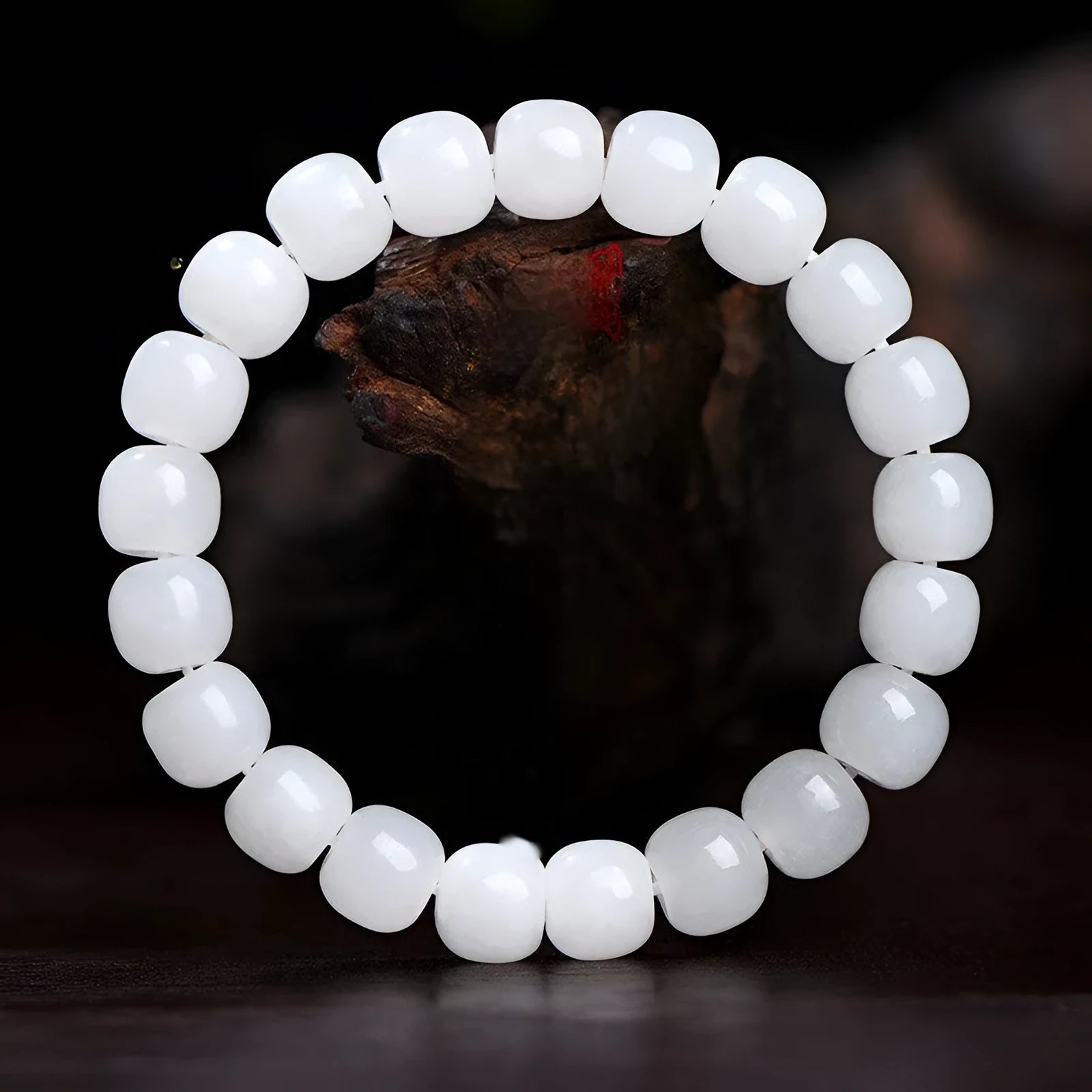 White jade barrel bead bracelet on wrist showing traditional Hetian jade material and barrel-shaped bead design
