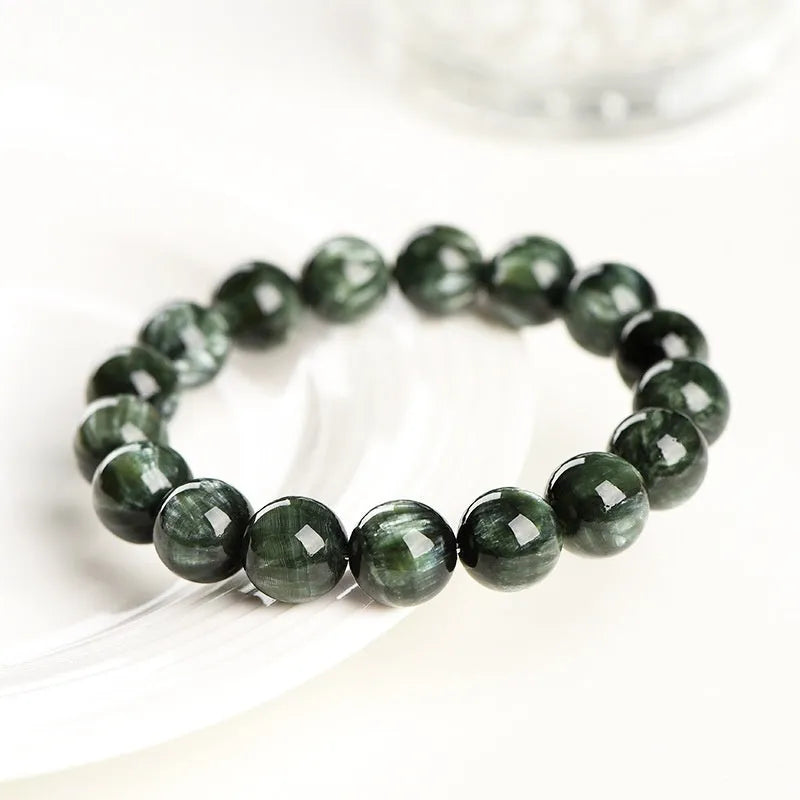 Green Dragon Crystal bracelet with 8-9mm round beads and Ruyi design elements on wrist