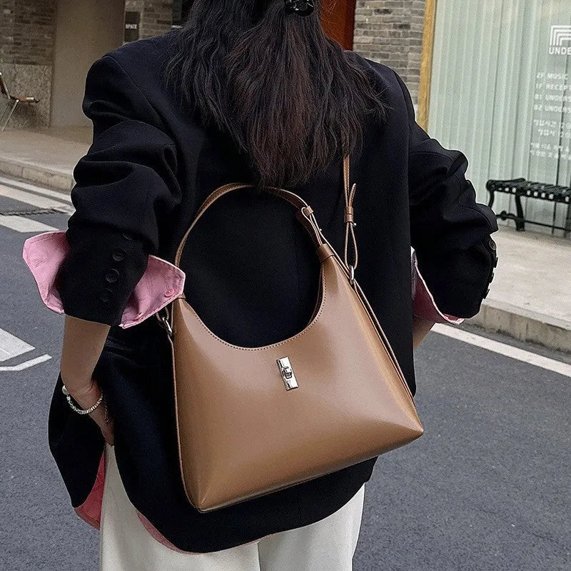 Soft genuine leather crossbody shoulder bag in a dumpling shape, shown in one of six available colours.