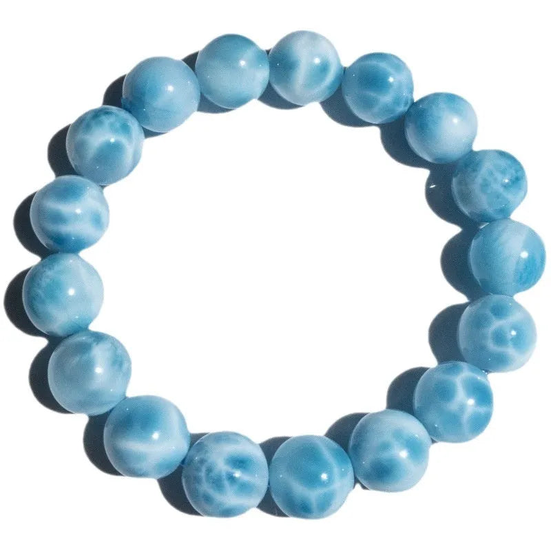Unisex blue pearl and natural crystal sea-pattern stone bodhi bracelet on a wrist, showing Maillard style design.