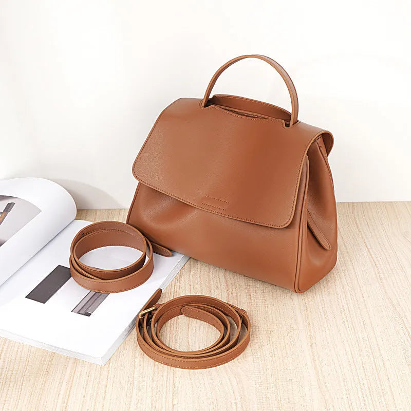 Soft genuine leather women's shoulder messenger bag in black, horizontal square shape with sewing thread detail