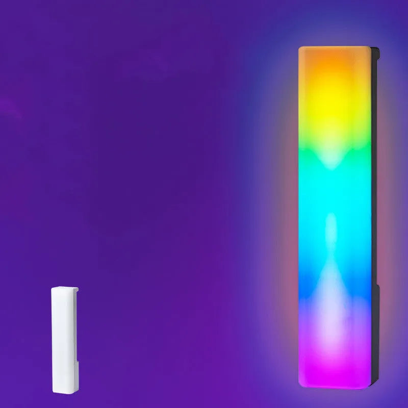 Black and white 3D RGB music rhythm ambiance lamp on a table with USB cable.