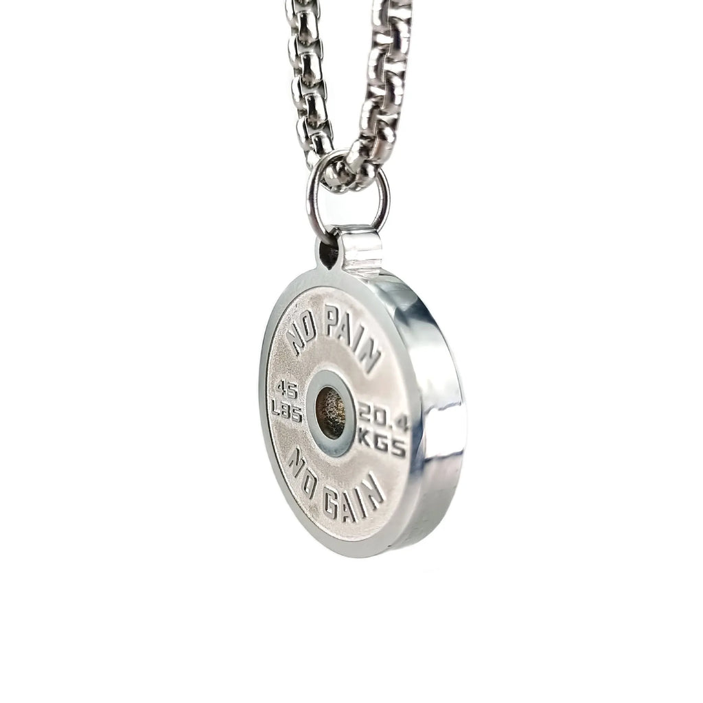 Polished stainless steel barbell disk geometric pendant necklace on a gold chain.