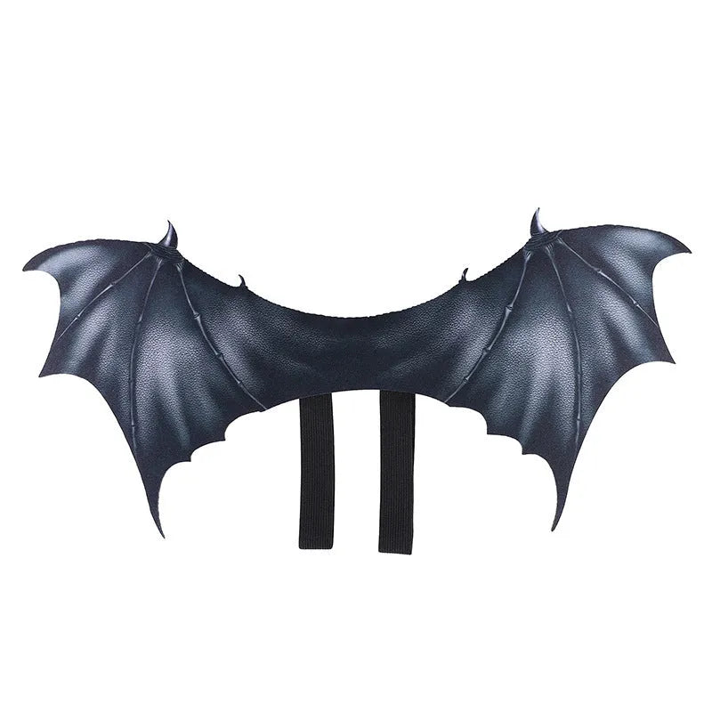 Black cloth bat wing costume for a cat or dog, showing large wing span.