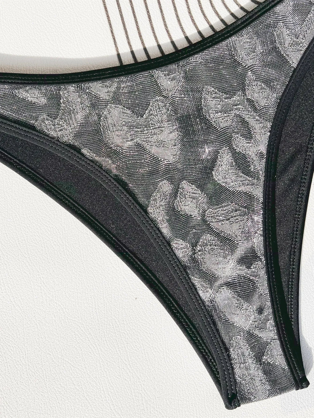 Black strappy women's bikini swimsuit made from polyester fabric.