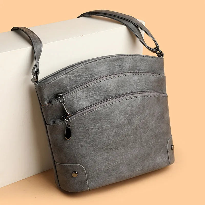 Large capacity multi-layer bucket bag in available colours including black, brown, and green