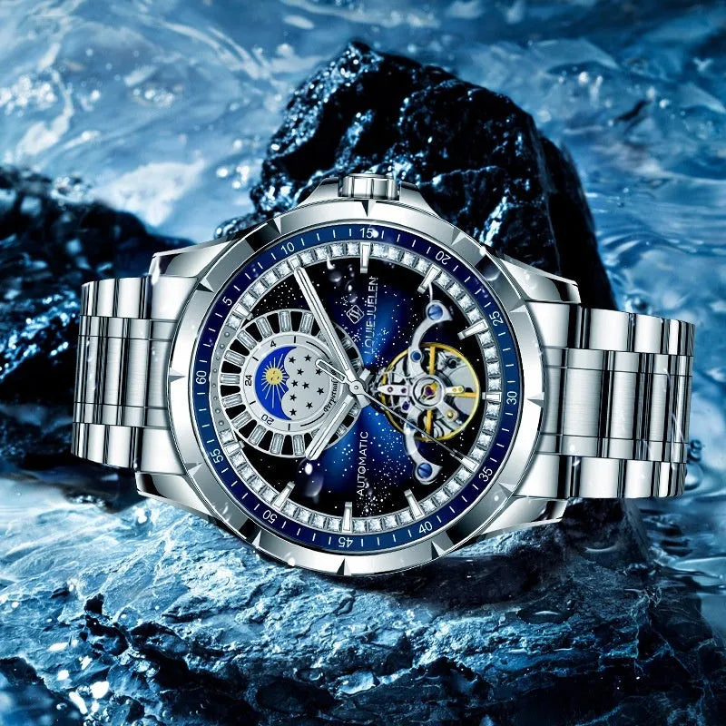 Men's silver automatic watch with blue dial and stainless steel strap showing transparent case back