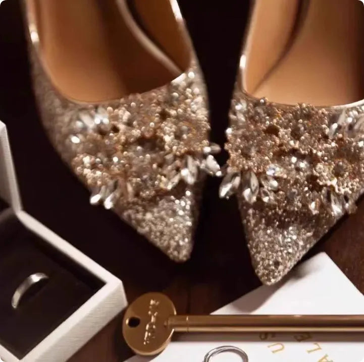 Champagne coloured pointed toe wedding heels with rhinestone floral detail on a fine heel.