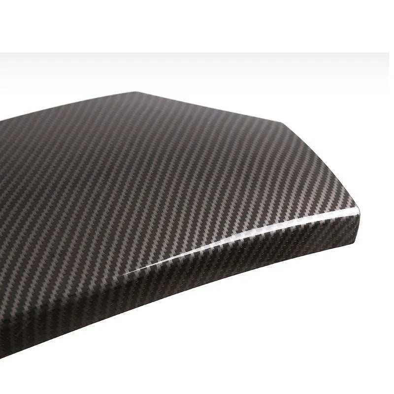 Three ABS carbon fibre pattern armrest box protective covers showing diagonal weave pattern and buckle installation system