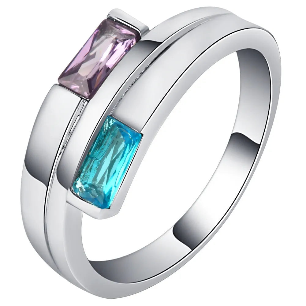 Silver-coloured copper ring with a central inlaid zircon stone, shown on a finger.