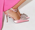 Women's pointed-toe satin sandal with heart rhinestone and cross-belt strap in black, pink, or white.