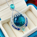 Blue geometric pendant necklace with fireworks cut gems and water wave chain