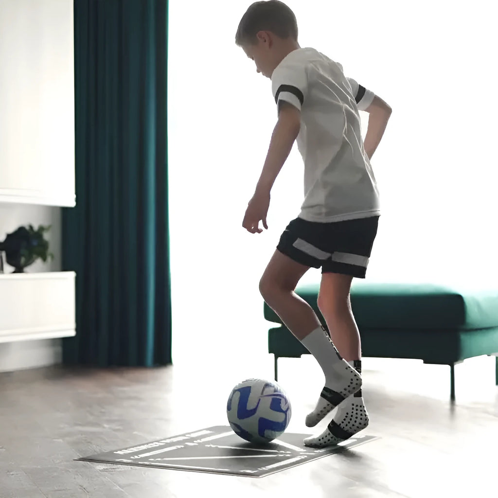 Black rectangular football training mat with textured non-slip surface measuring 60cm by 90cm
