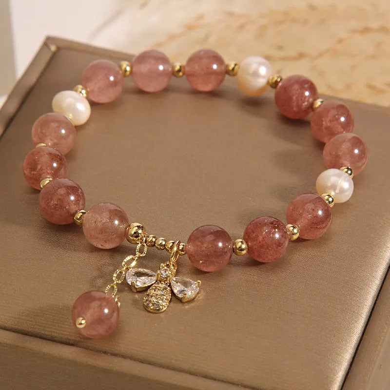 Women's bracelet with strawberry quartz stones, freshwater pearls, and zircon accents on an alloy chain.