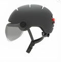 Cycling helmet with red LED brake light on the tail, shown in two sizes and styles.