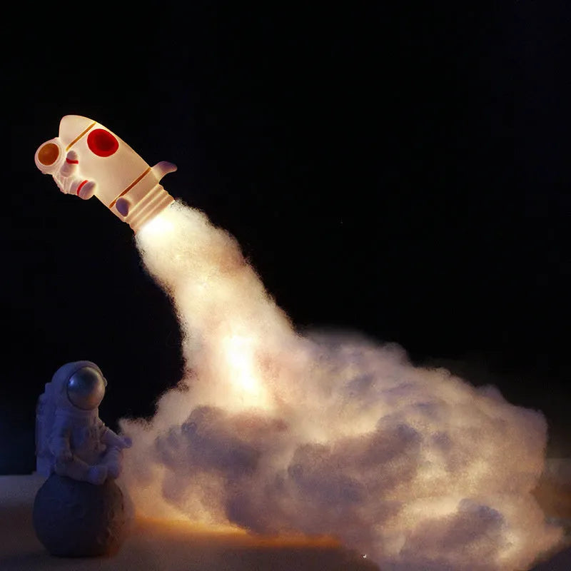DIY astronaut rocket LED night light kit components including small model, straws, chassis, and string lights for assembly.