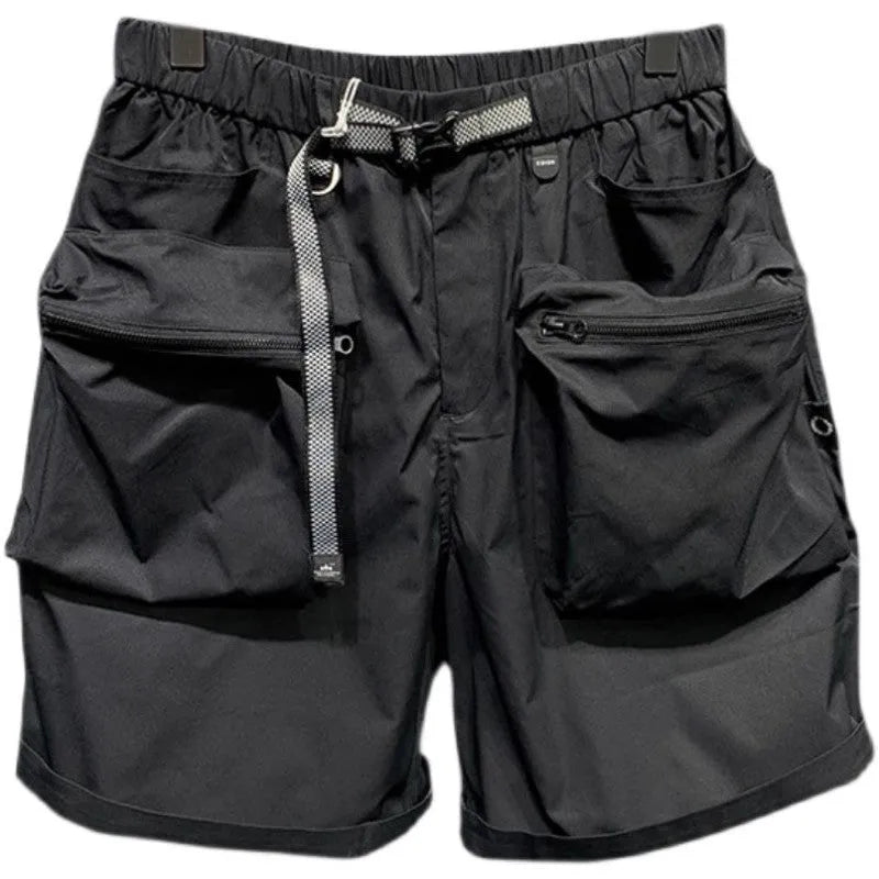 Men's solid black loose-fit work shorts with pockets, shown above the knee.