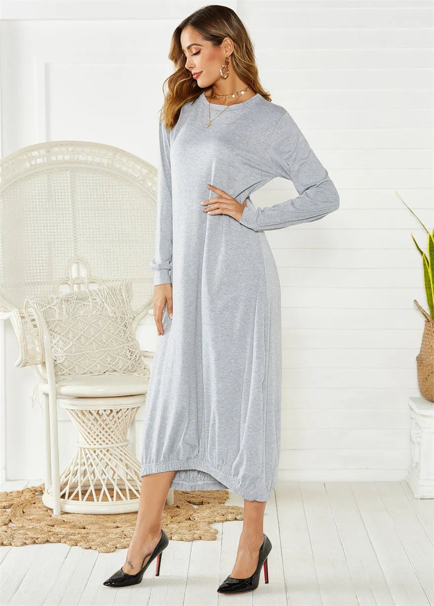 A loose black lantern dress with a lace-up crew neck, shown on a model.