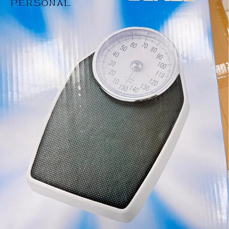 Black mechanical body weight scale with large dial showing weight measurements.