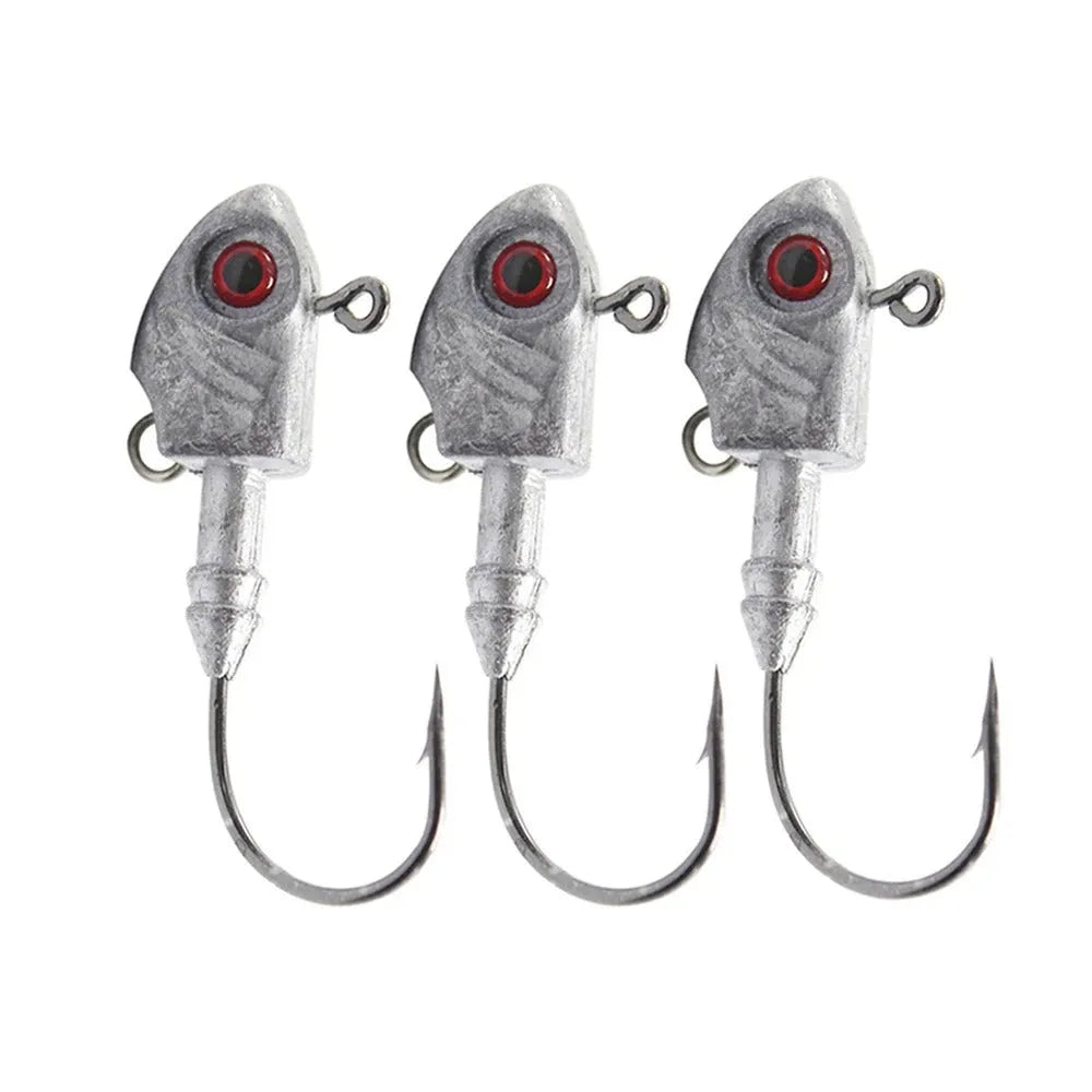 Simulation Yayu shaped lead head fishing jig hooks in blue, silver, yellow colours on a tackle background.