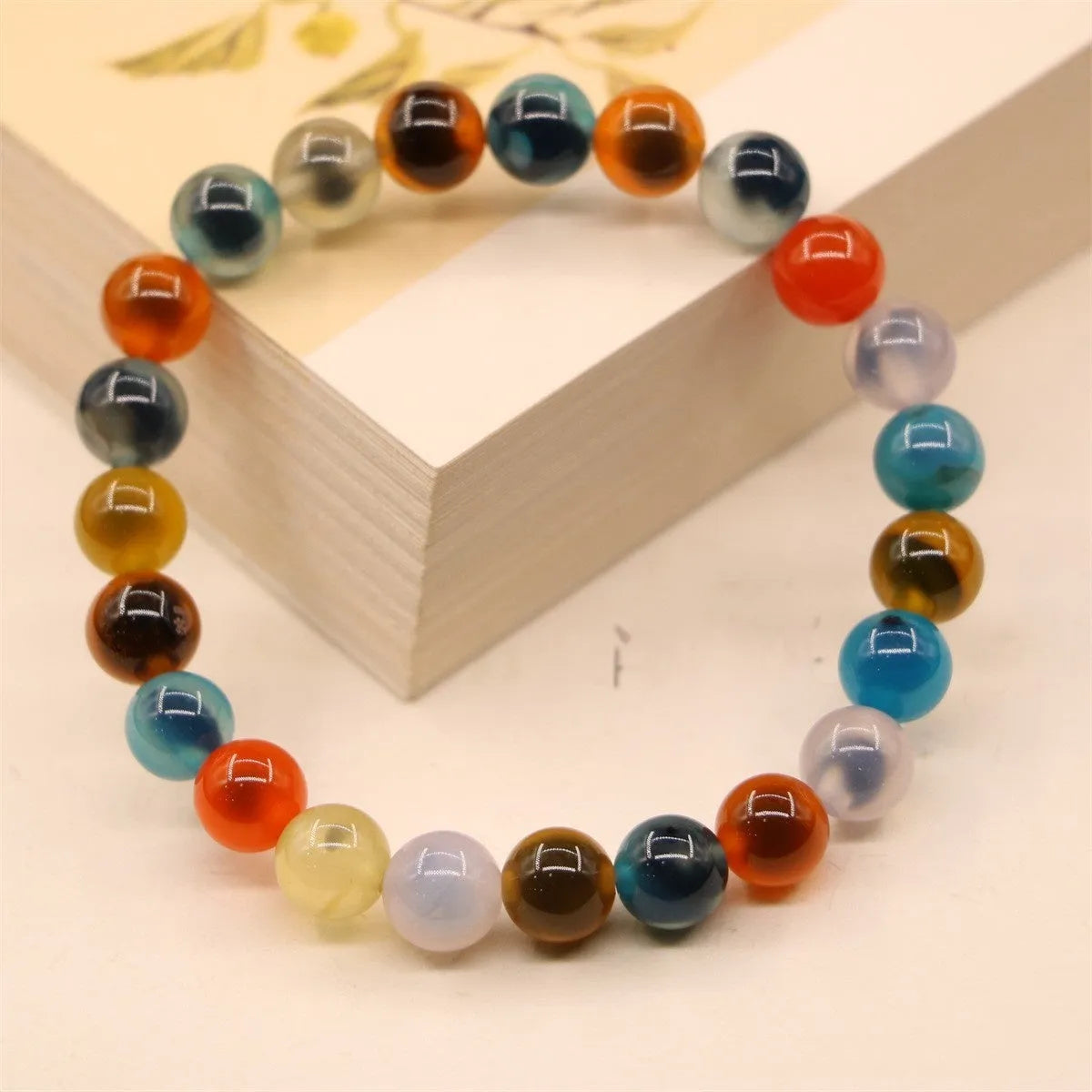 Women's geometric bracelet with colourful sugar heart agate beads and a detailed copper coin snake chain.