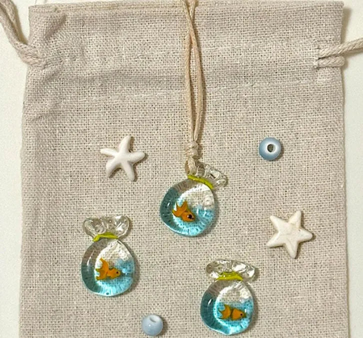 Women's skirt and joker charm pendant necklace with coloured glass on a cotton linen clavicle chain.