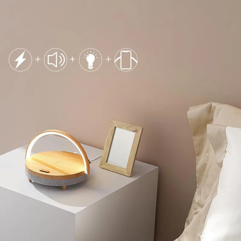 Wireless charging LED night light with Bluetooth speaker in marble pattern finish showing phone holder